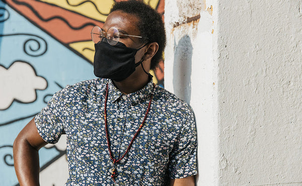 Person wearing the V4 Mask in Black 100% Cotton Flannel while wearing glasses.